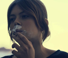 young girl smoking a cigarette