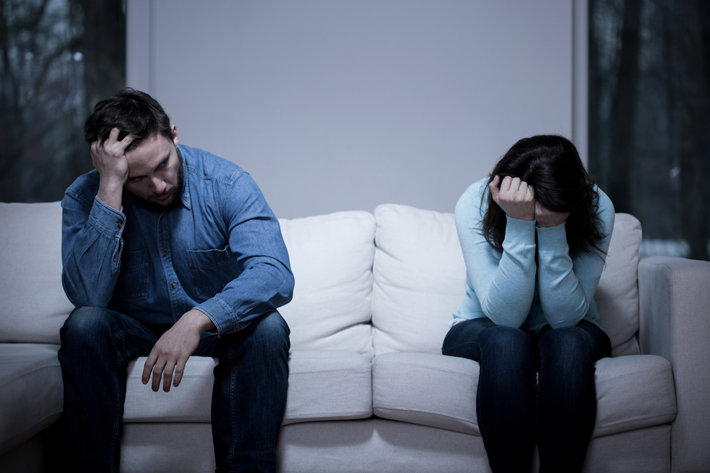 Depressed couple at home, addiction problems.